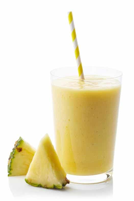 Glass of fresh healthy pineapple smoothie isolated on white background